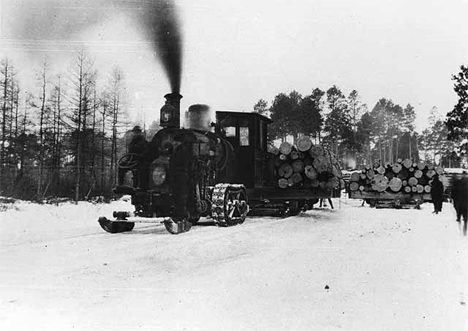 Tractor pulling sleds loaded with logs in the Pine Island area west of Big Falls, 1902